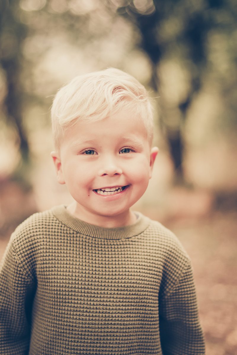Herbstliches Kinderporträt im Strickpulli beim Kita-Fototag
